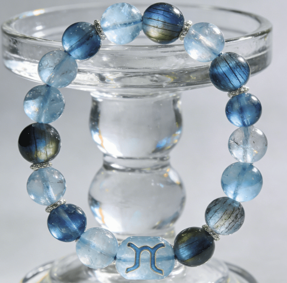 Aquarius innovative mala bracelet with aquamarine and labradorite beads on frosted glass tabletop