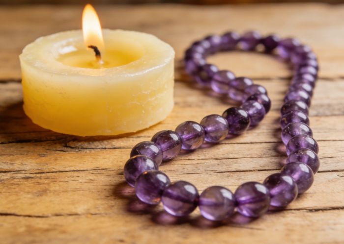 Amethyst mala with lit candle 