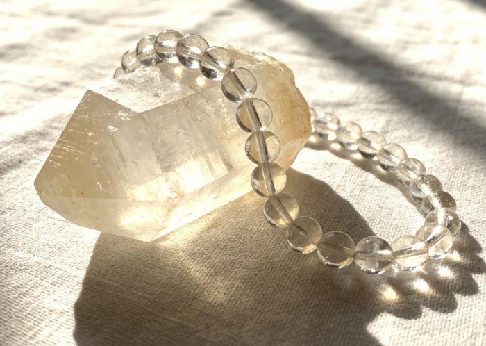 Clear quartz mala on selenite